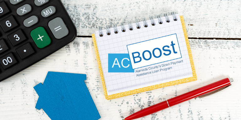 Photo of a calculator, figurine of a house, and a pen with a notebook on which is the AC Boost logo.