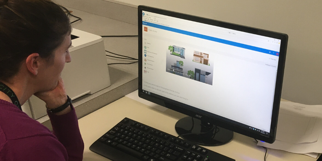 A woman staring at a computer screen