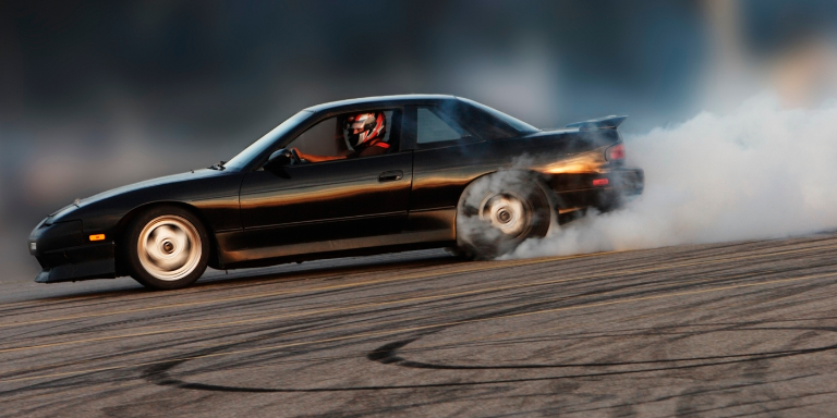 Black care on the street doing donuts.
