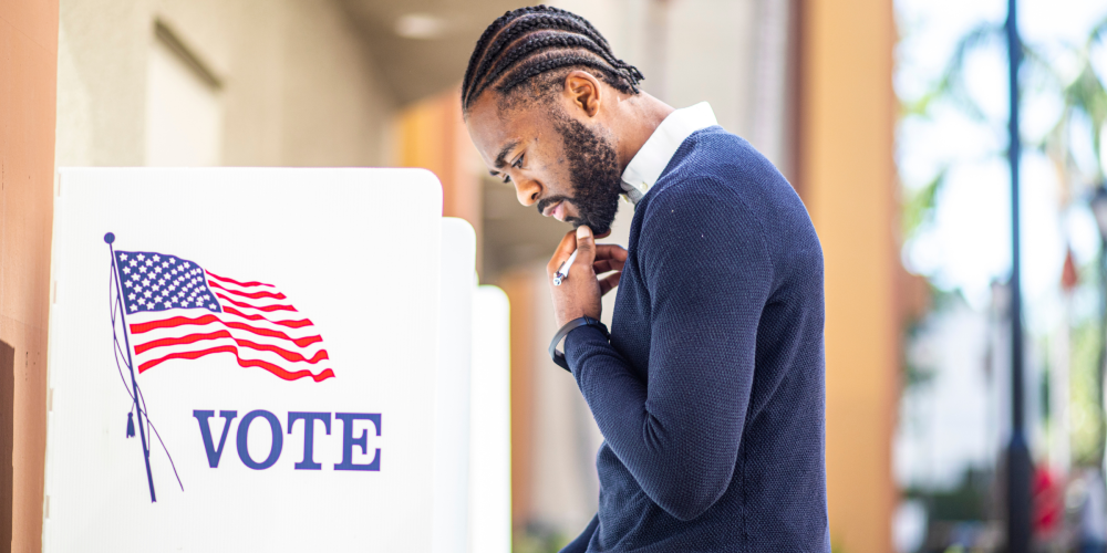 A man at a voter box