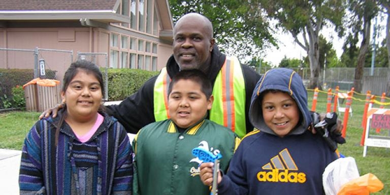 An adult and three students preparing to join a clean up at Weekes Park
