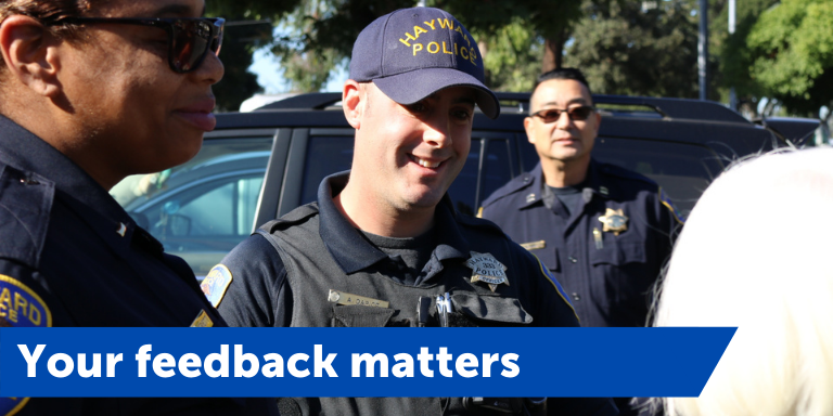 A group of officers smiling at community members during Coffee with a Cop. A blue banner with the text, your feedback matters, is at the bottom of the page
