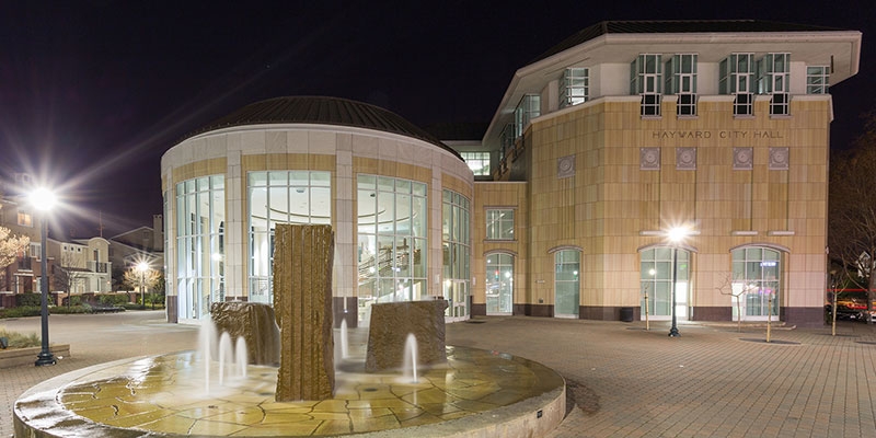 Hayward City Hall lit brightly at night