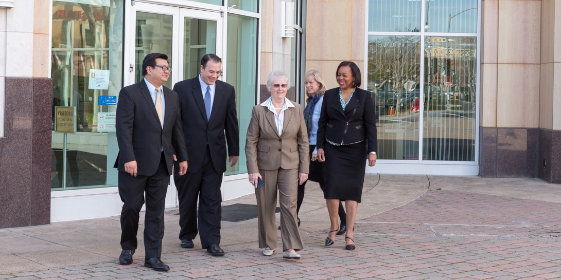 A group of City of Hayward employees walking in front of City Hall