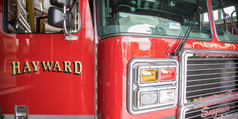 a red fire truck with Hayward in gold on the open door