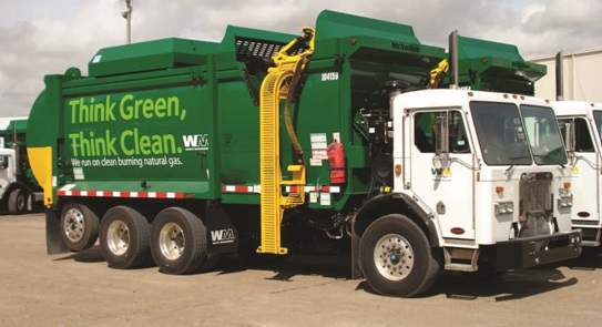 Green and white waste management garbage truck. Text on the side of the truck reads: Think Green. Think Clean. 